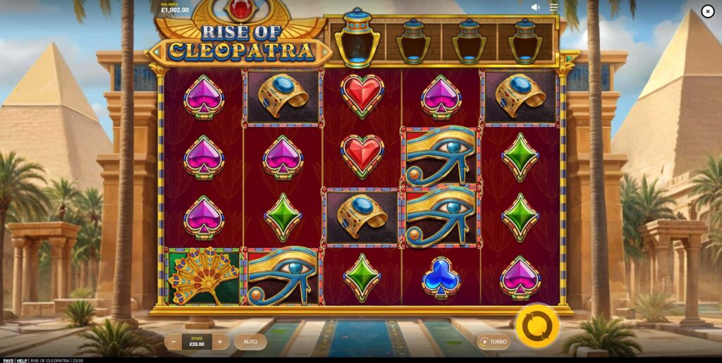 The base game screen of the Rise of Cleopatra slot showing the five reels and Egyptian symbols.